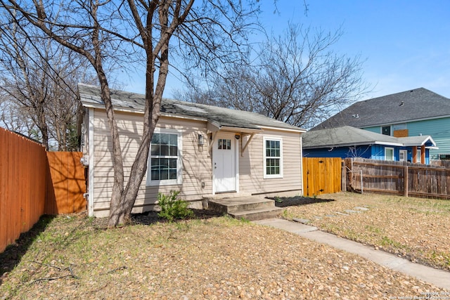 bungalow-style home with a fenced backyard