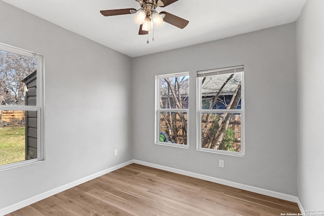unfurnished room featuring ceiling fan, baseboards, and wood finished floors