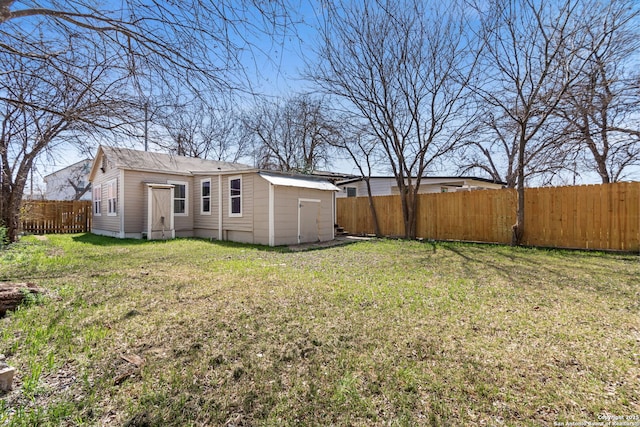 view of yard with an outbuilding and a fenced backyard