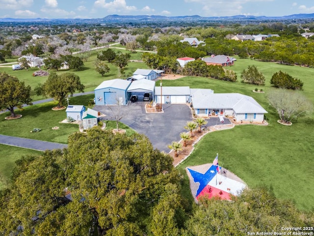 birds eye view of property with a mountain view