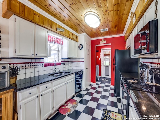 kitchen featuring dark floors, crown molding, stainless steel electric stove, visible vents, and a sink