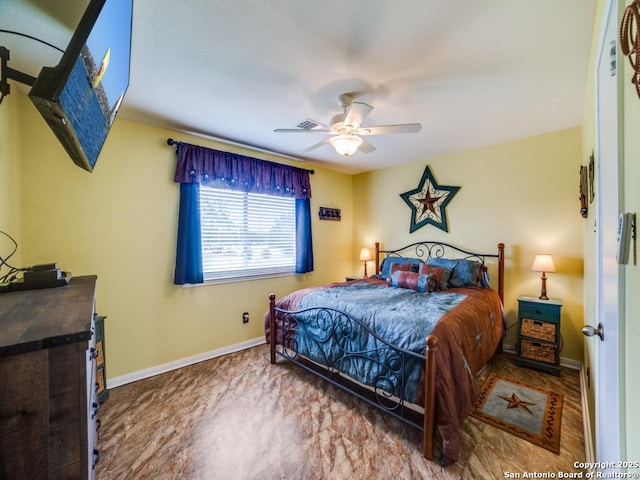 bedroom featuring a ceiling fan, visible vents, and baseboards