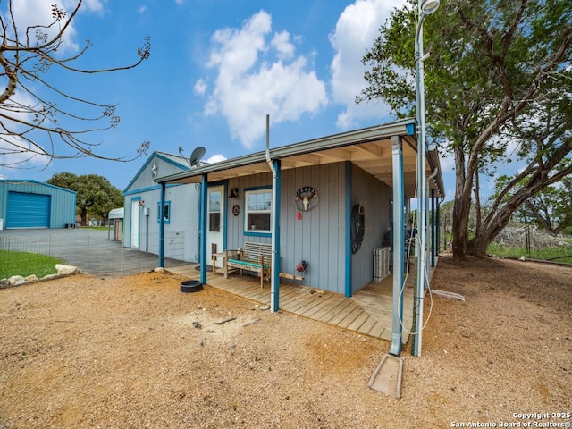 exterior space featuring cooling unit and an outdoor structure