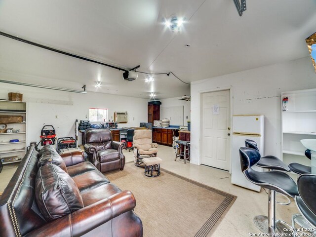 interior space featuring a garage door opener and freestanding refrigerator