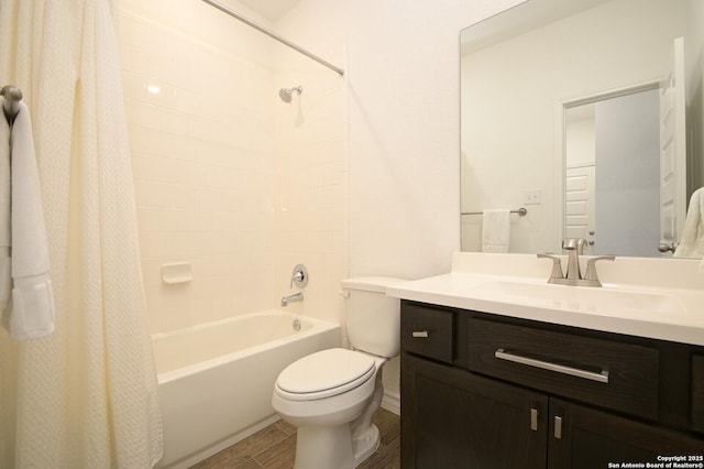 bathroom featuring toilet, wood finished floors, shower / tub combo with curtain, and vanity