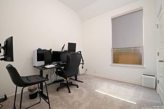 home office featuring lofted ceiling, carpet, and baseboards