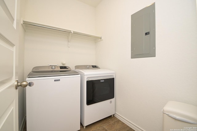 laundry area with laundry area, electric panel, baseboards, and separate washer and dryer