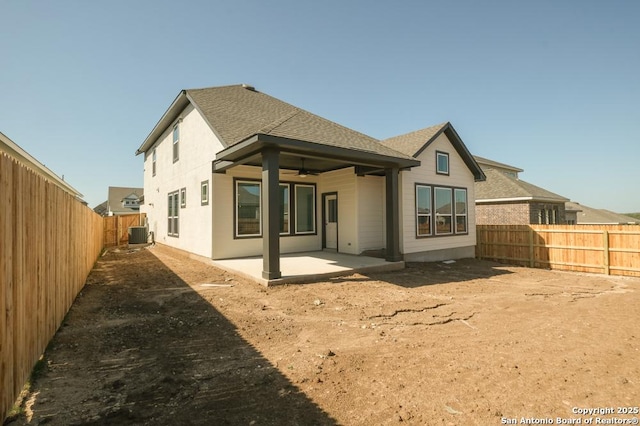 2614 Vistablue, San Antonio, TX 78245 - back of house with central air condition unit, a ceiling fan, a patio area, a fenced backyard, and a shingled roof