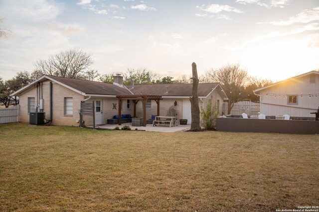 back of house with a patio, a lawn, central AC unit, fence, and a pergola