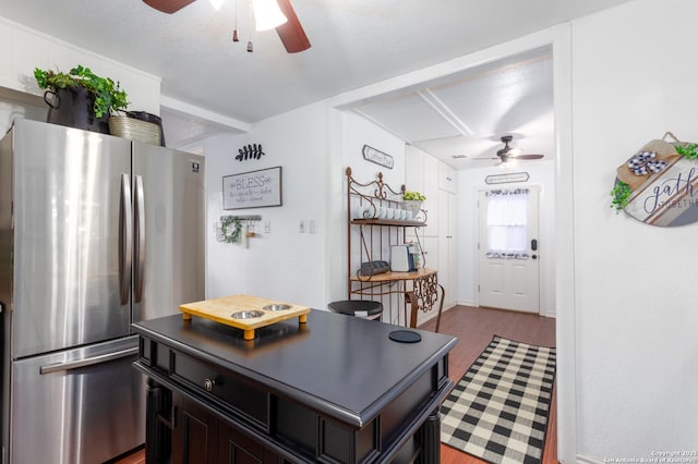 kitchen with a ceiling fan, freestanding refrigerator, and wood finished floors