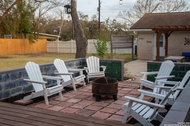 view of patio with a fenced backyard and a fire pit