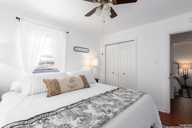 bedroom with ceiling fan, baseboards, a closet, and wood finished floors