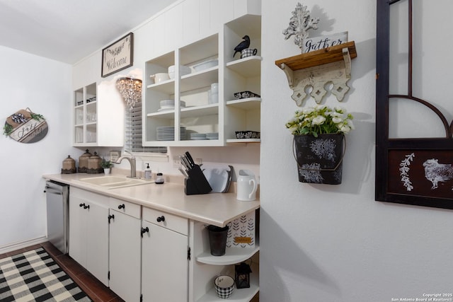 kitchen with a sink, white cabinets, light countertops, stainless steel dishwasher, and open shelves