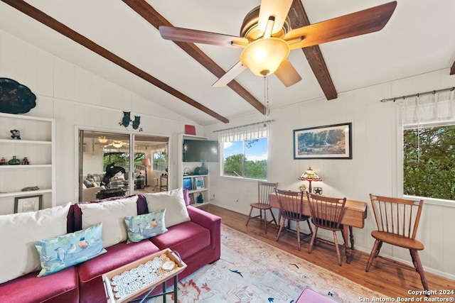 living room with lofted ceiling with beams, ceiling fan, and wood finished floors