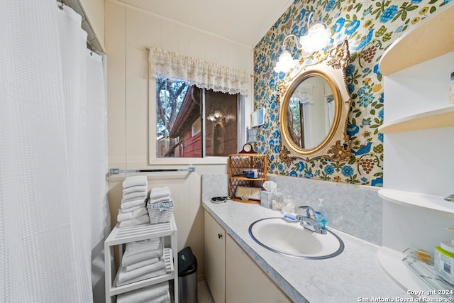 full bathroom with vanity and wallpapered walls