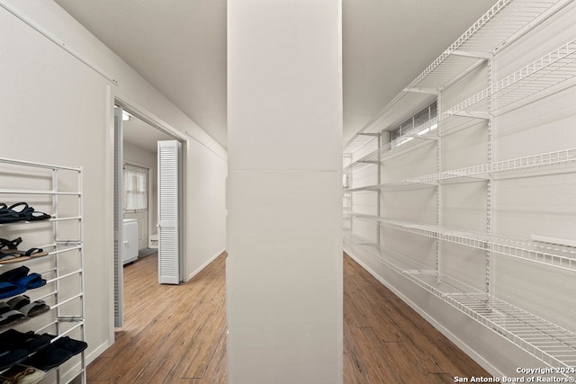 interior space featuring baseboards and wood finished floors