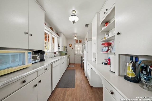 kitchen featuring white appliances, visible vents, white cabinetry, light countertops, and open shelves