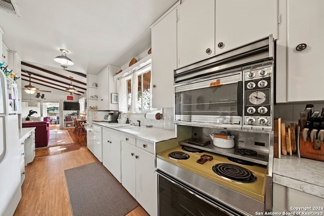 kitchen featuring visible vents, white cabinets, ceiling fan, light countertops, and backsplash