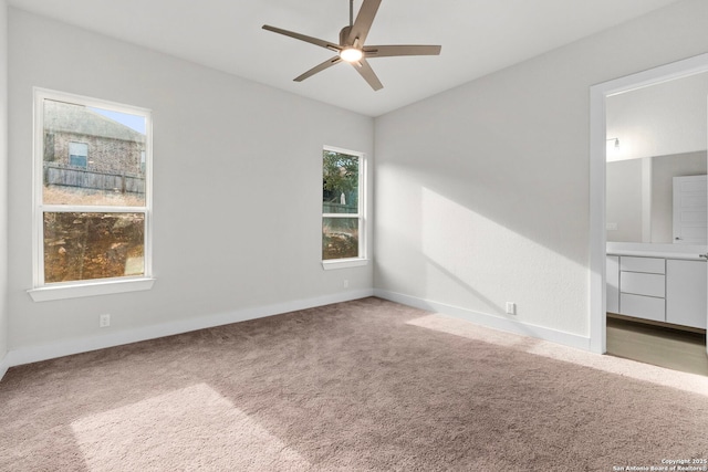 interior space with ceiling fan and baseboards