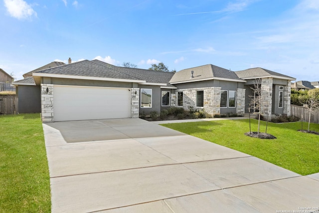 view of front of home with a garage, stone siding, driveway, and a front lawn