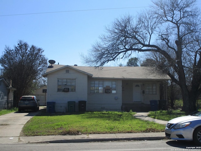 view of front of property with a front yard and concrete driveway