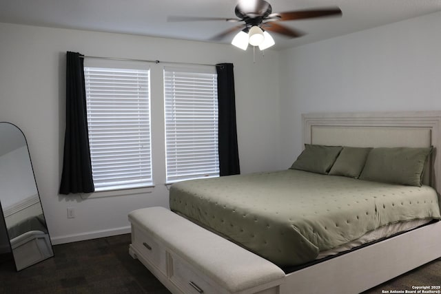 bedroom featuring ceiling fan and baseboards