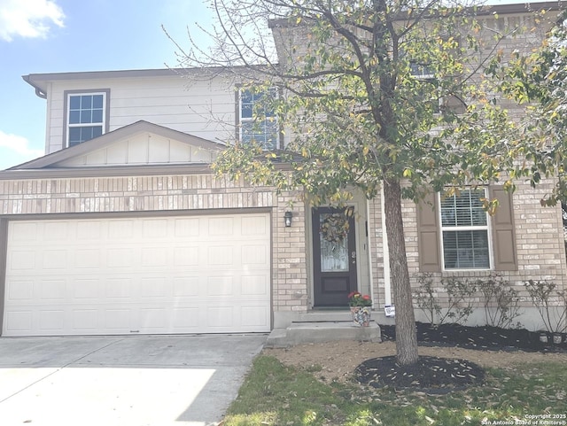 view of front of house with board and batten siding, brick siding, driveway, and an attached garage