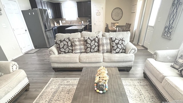 living area featuring baseboards and wood finished floors