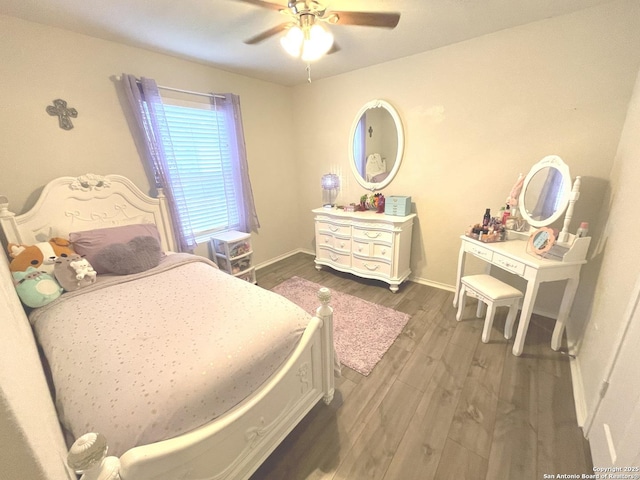 bedroom featuring ceiling fan, wood finished floors, and baseboards