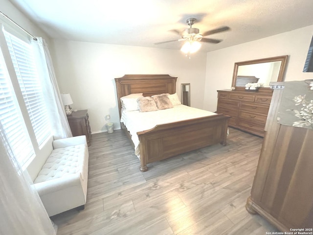 bedroom featuring light wood-style floors and ceiling fan