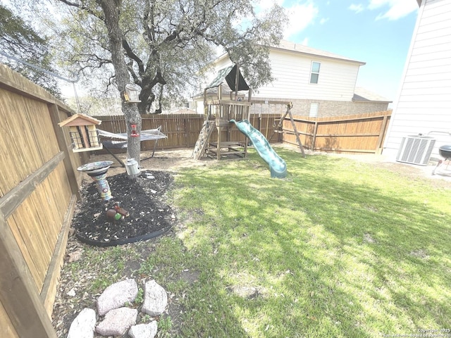 view of yard featuring a fenced backyard, a playground, and cooling unit