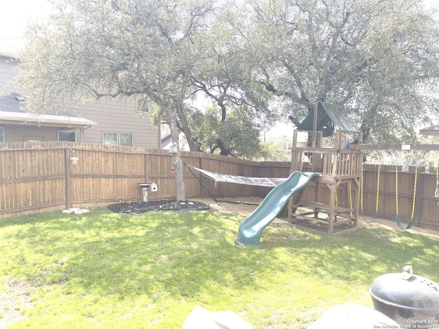 view of play area featuring a fenced backyard and a yard