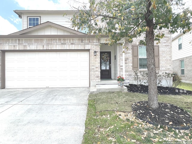 view of front facade featuring a garage, concrete driveway, brick siding, and board and batten siding