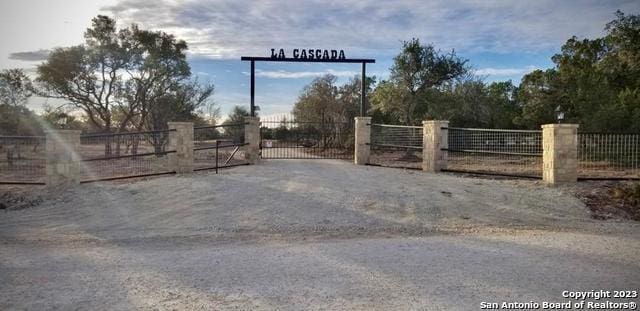 view of gate with fence