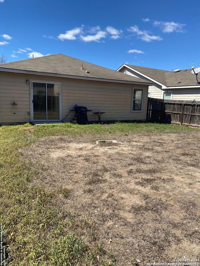 rear view of property with fence