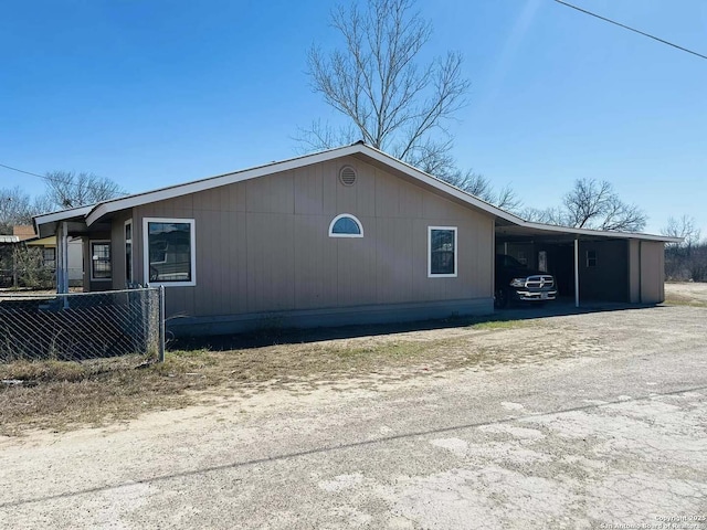 view of side of home featuring a carport and driveway