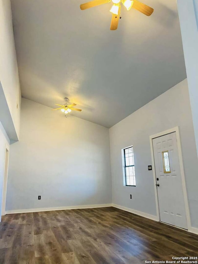 foyer featuring lofted ceiling, a ceiling fan, baseboards, and wood finished floors