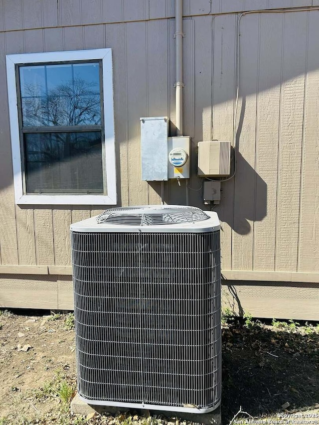 exterior details featuring electric meter and cooling unit