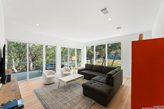 living room featuring recessed lighting, visible vents, and wood finished floors