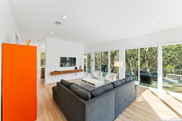 living area featuring light wood-style floors, visible vents, and recessed lighting