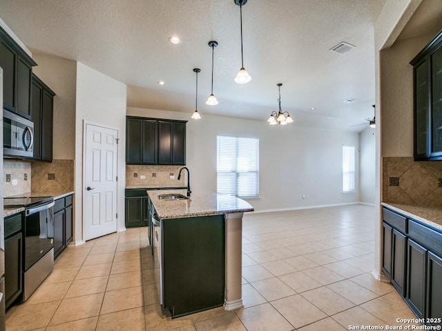 kitchen with light tile patterned floors, a sink, visible vents, electric range oven, and stainless steel microwave