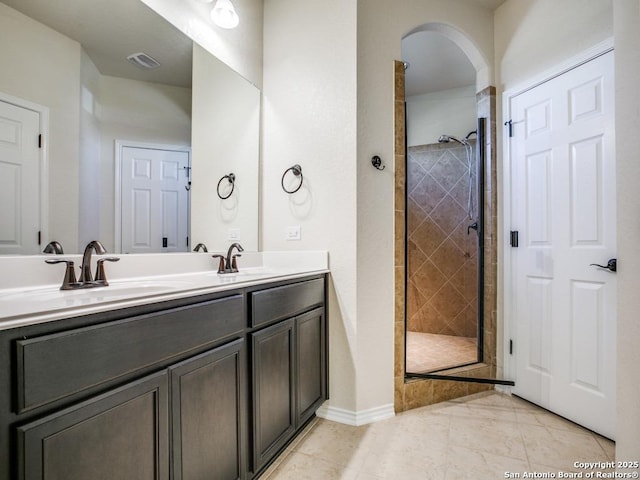 full bathroom with a stall shower, a sink, and visible vents