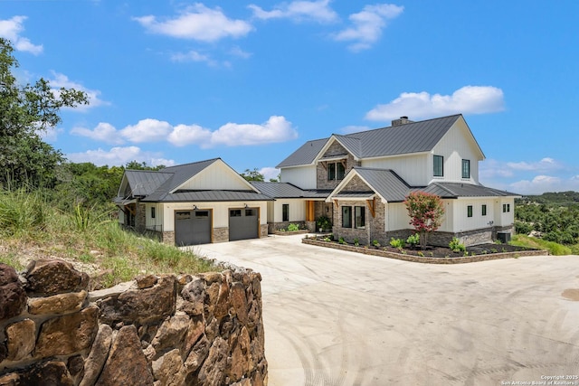 modern inspired farmhouse featuring a standing seam roof, stone siding, and metal roof