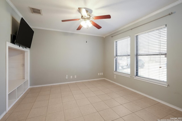 empty room featuring baseboards, a ceiling fan, visible vents, and crown molding