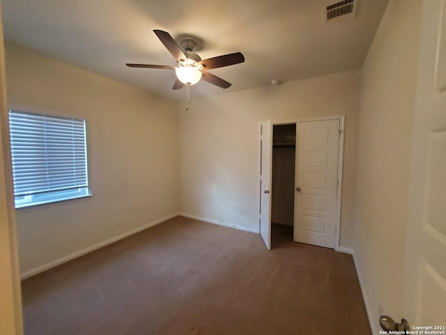 unfurnished bedroom with ceiling fan, carpet floors, visible vents, baseboards, and a closet