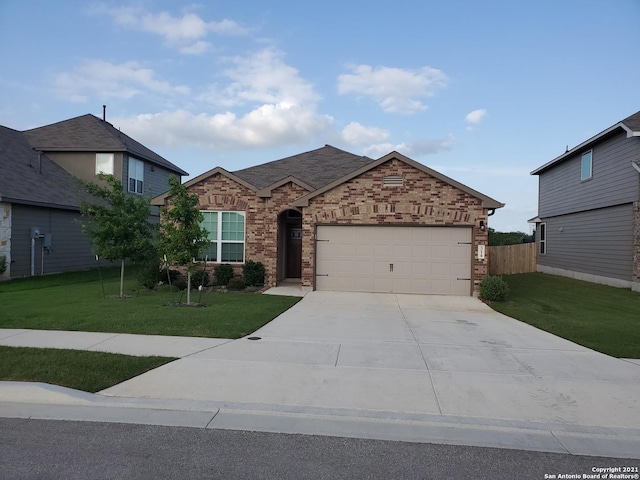 view of front facade with an attached garage, brick siding, fence, driveway, and a front yard