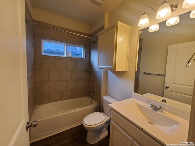 bathroom featuring toilet, washtub / shower combination, wood finished floors, and vanity