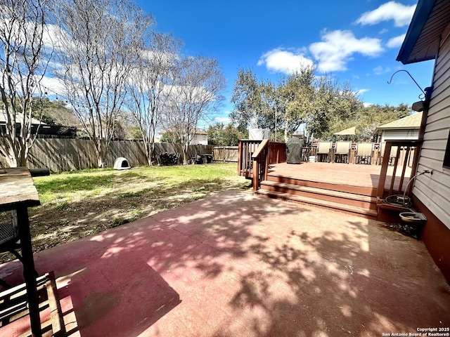 view of patio featuring a deck and a fenced backyard