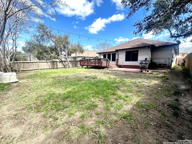 view of yard with a patio area, a fenced backyard, a deck, and cooling unit