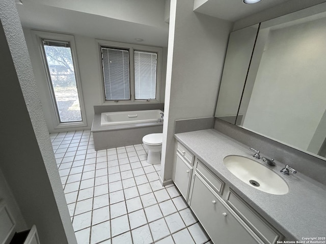 full bath featuring a bath, toilet, vanity, and tile patterned floors